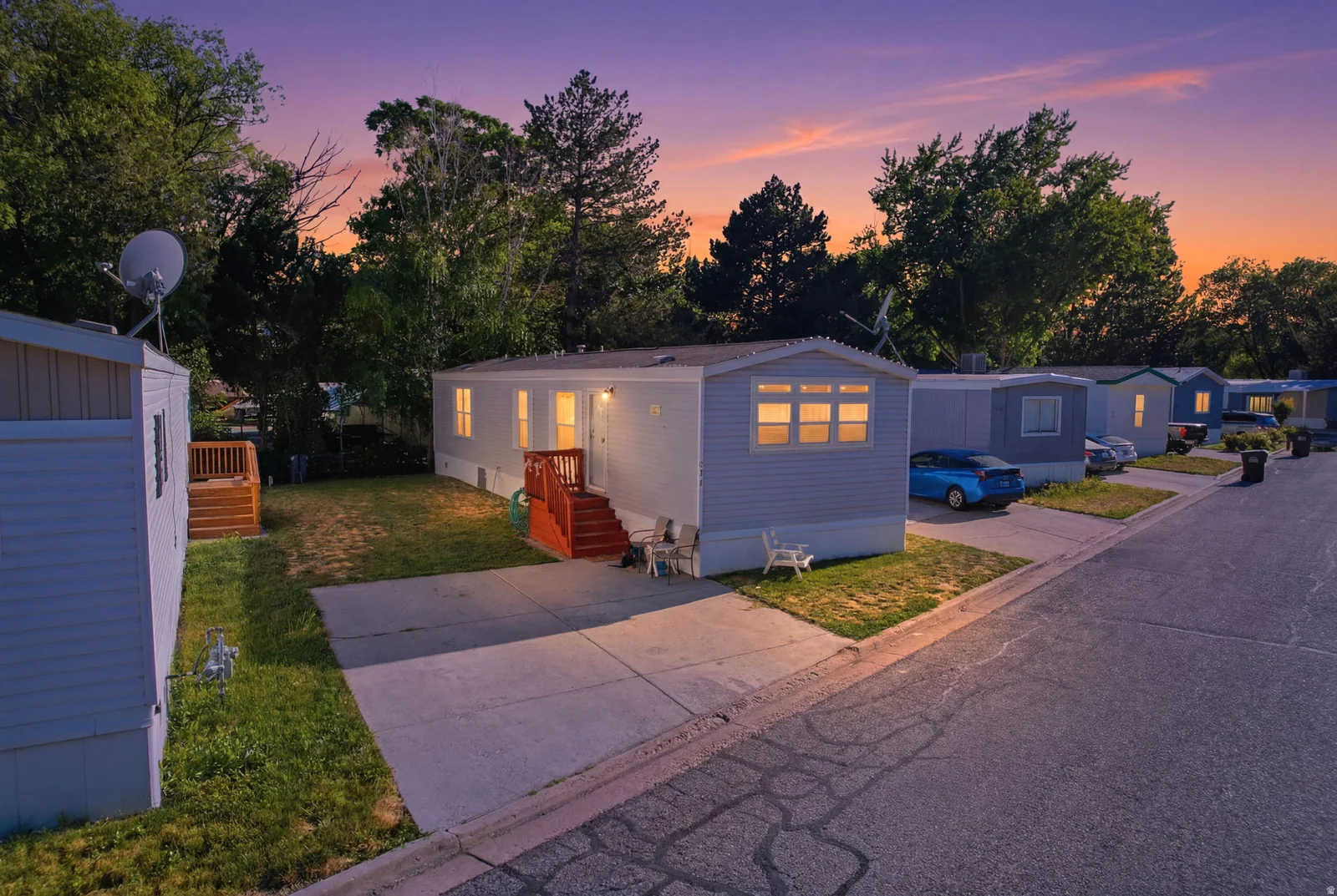 Light blue siding exterior with a red-painted entrance deck and stairs